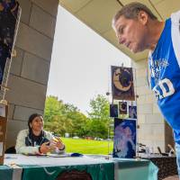 Parent looking at display during Student Small Business Market.